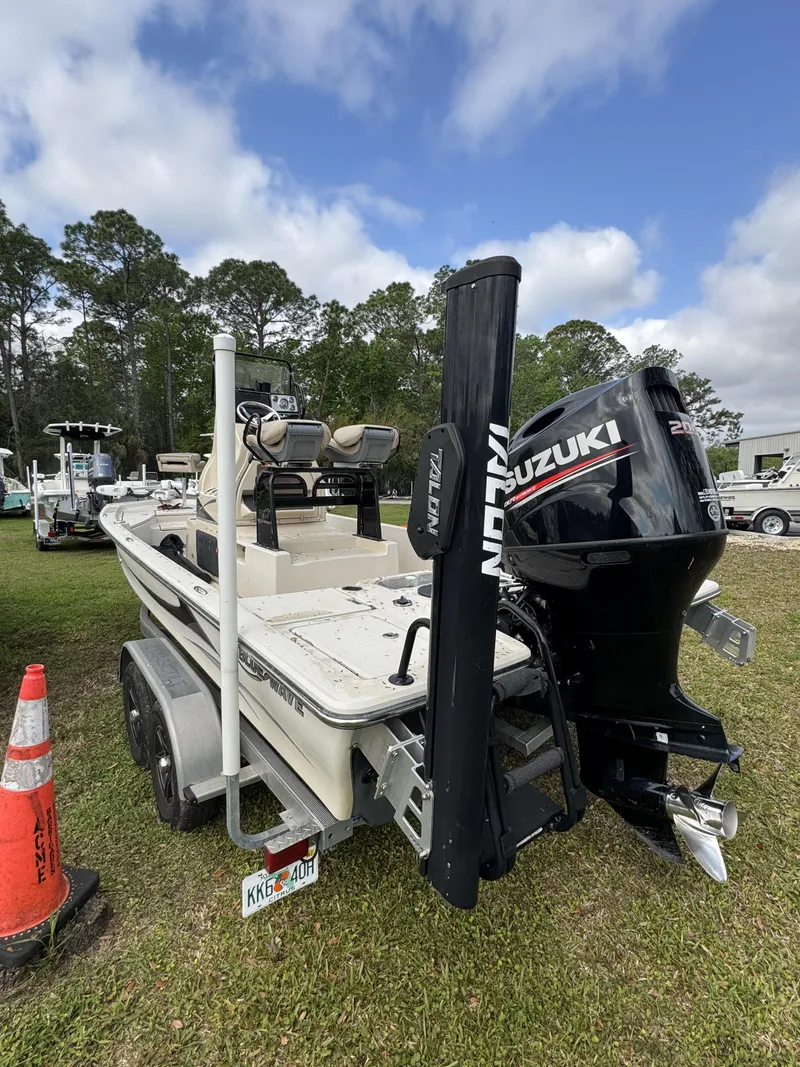 Slide: The Image of 2020 Blue Wave 2200 PureBay boat with Suzuki engine parked outdoors. - 5