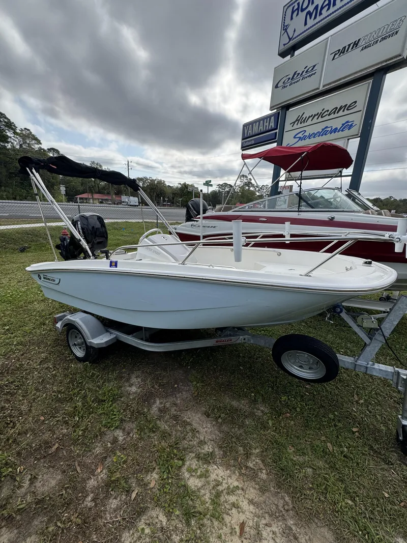 Slide: The Image of 2024 Boston Whaler 130 Super Sport boat on trailer. - 11