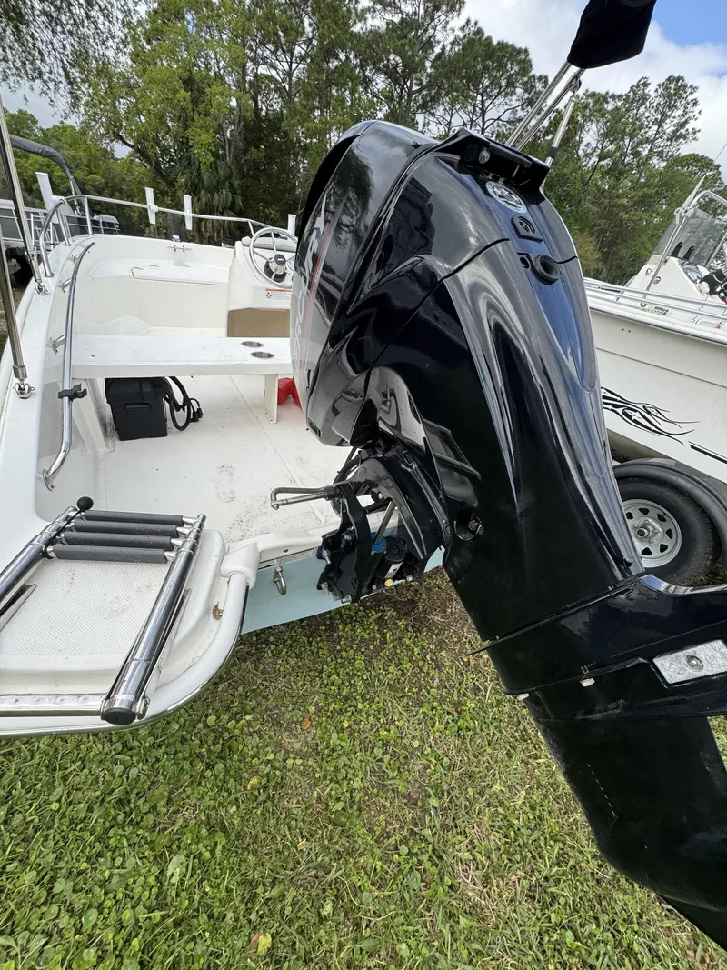 Slide: The Image of 2024 Boston Whaler 130 Super Sport with outboard motor. - 13