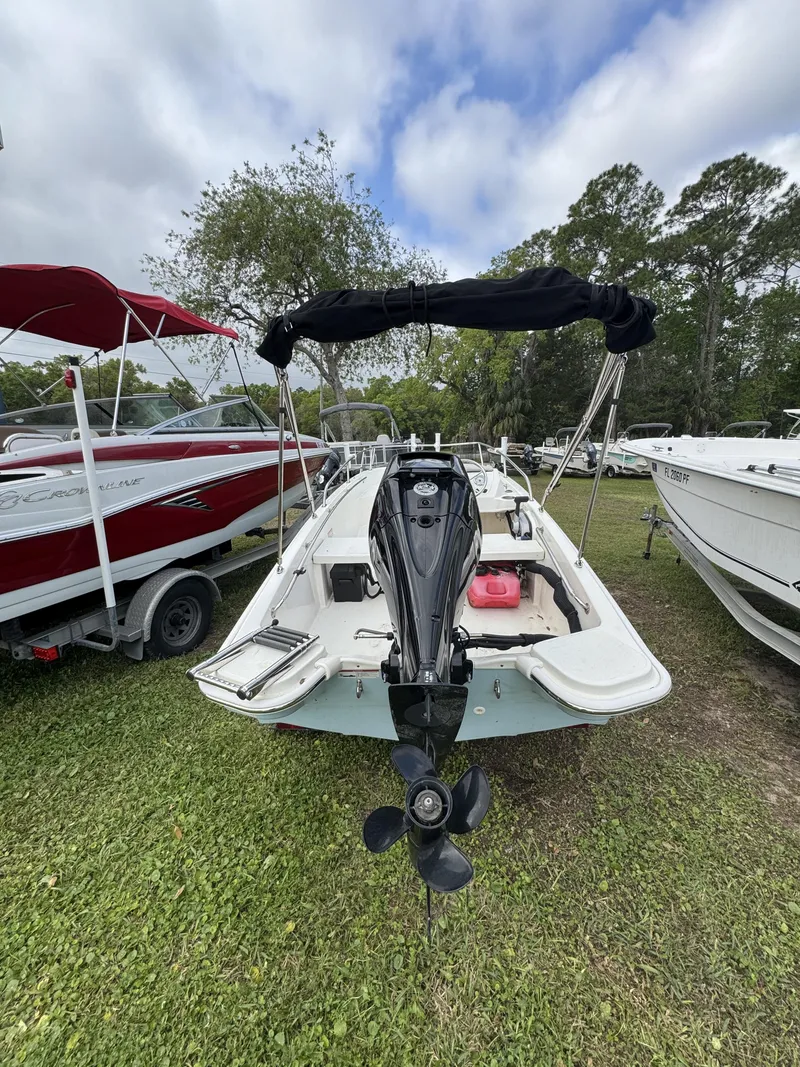 Slide: The Image of 2024 Boston Whaler 130 Super Sport boat parked on grass. - 14