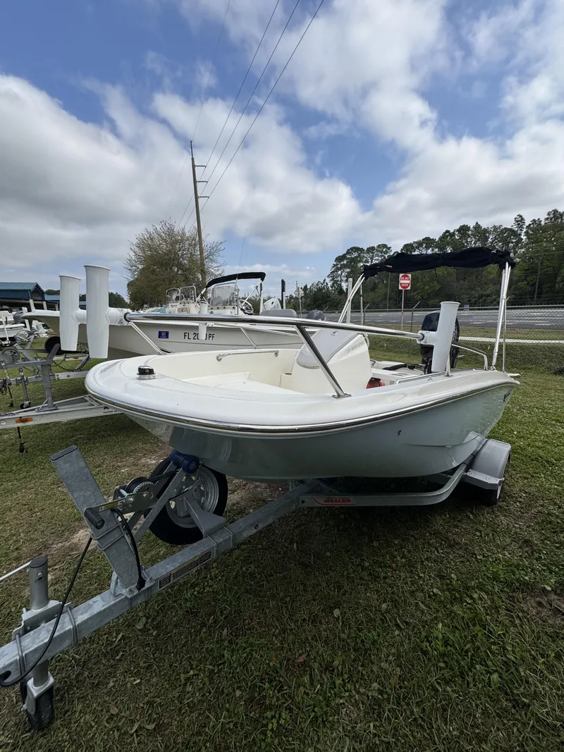 Slide: The Image of 2024 Boston Whaler 130 Super Sport on trailer, parked outdoors. - 5