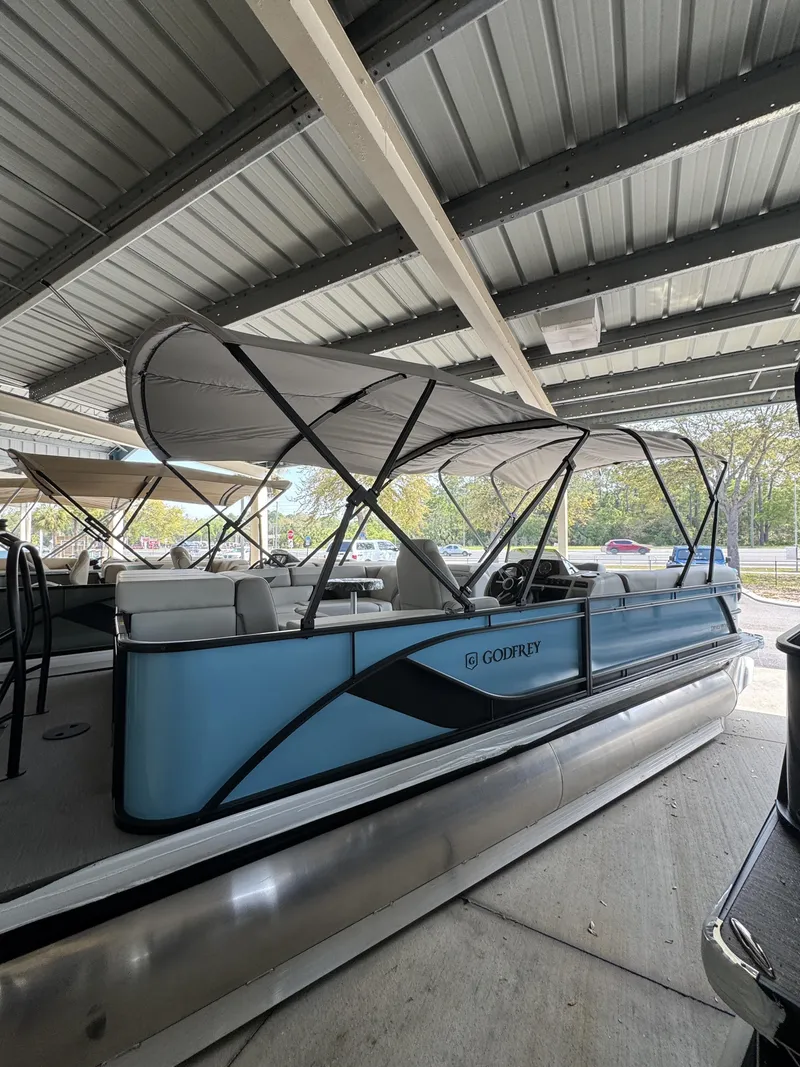 Slide: The Image of 2026 Godfrey SW 2286 Cruise Special Edition pontoon boat under shelter. - 3