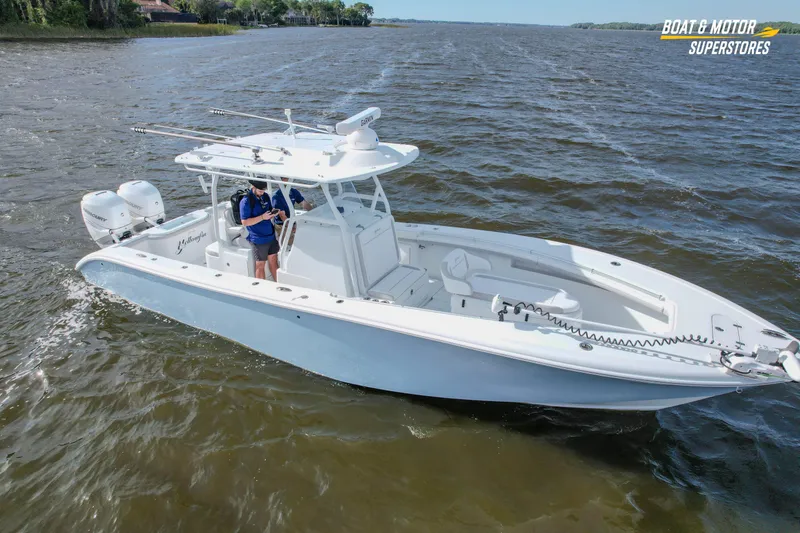 Slide: The Image of 2020 Yellowfin 32 Offshore boat cruising on open water, featuring dual outboard engines. - 11