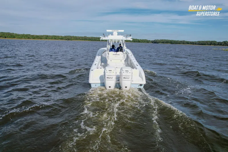 Slide: The Image of 2020 Yellowfin 32 Offshore boat cruising on open water with twin 400 engines. - 12