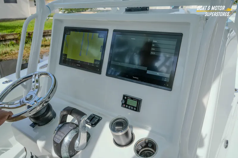 Slide: The Image of 2020 Yellowfin 32 Offshore boat dashboard with dual Garmin displays and steering wheel. - 13