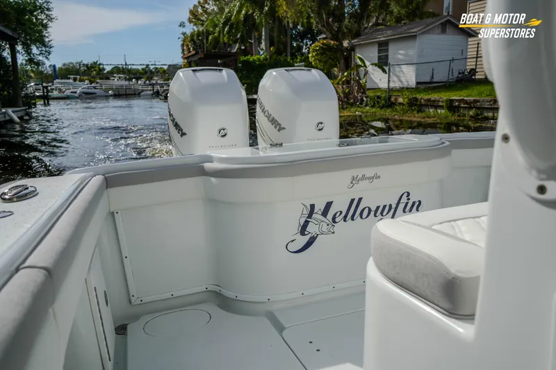 Slide: The Image of 2020 Yellowfin 32 Offshore boat with twin Mercury engines docked by the water. - 14