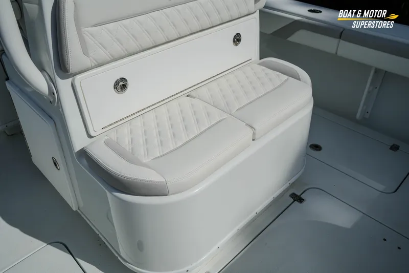 Slide: The Image of 2020 Yellowfin 32 Offshore boat interior with white cushioned seating. - 16
