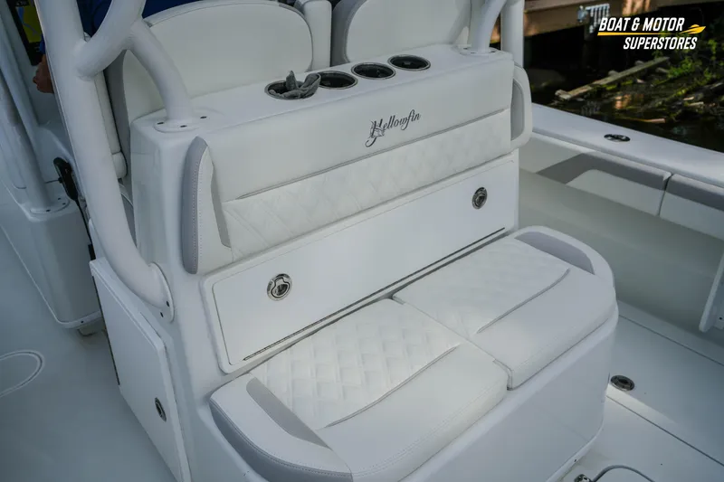 Slide: The Image of 2020 Yellowfin 32 Offshore boat interior with white cushioned seating and cup holders. - 17