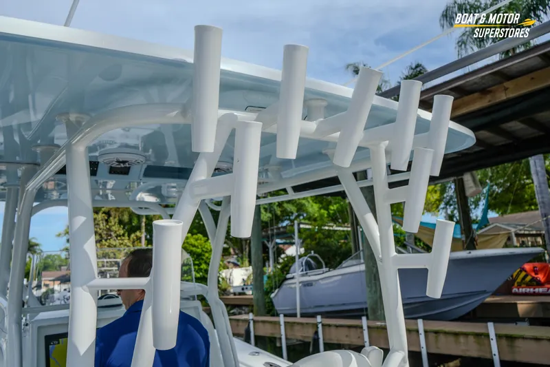 Slide: The Image of 2020 Yellowfin 32 Offshore boat with rod holders, docked near a marina. - 18