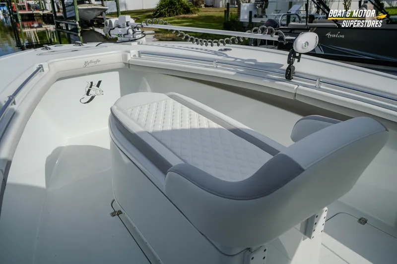 Slide: The Image of 2020 Yellowfin 32 Offshore boat interior with cushioned seating and fishing rod holders. - 24