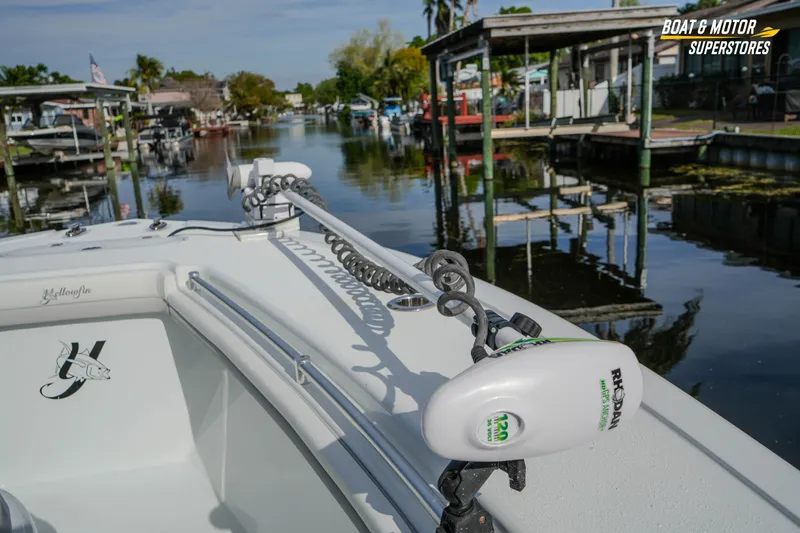 Slide: The Image of 2020 Yellowfin 32 Offshore boat docked in a serene waterfront setting. - 27