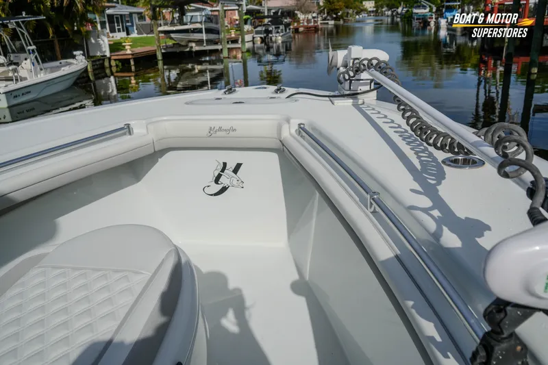 Slide: The Image of 2020 Yellowfin 32 Offshore boat interior with logo, docked in a scenic marina. - 28