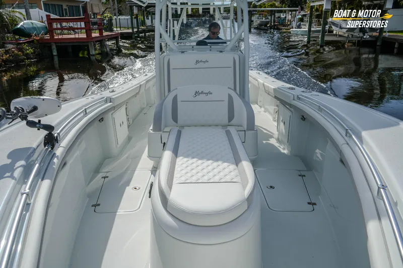 Slide: The Image of 2020 Yellowfin 32 Offshore boat interior with luxurious seating on a calm waterway. - 32