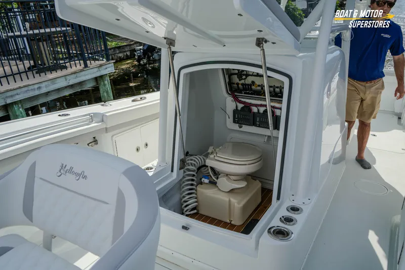 Slide: The Image of 2020 Yellowfin 32 Offshore boat with open console showing marine toilet and wiring. - 38