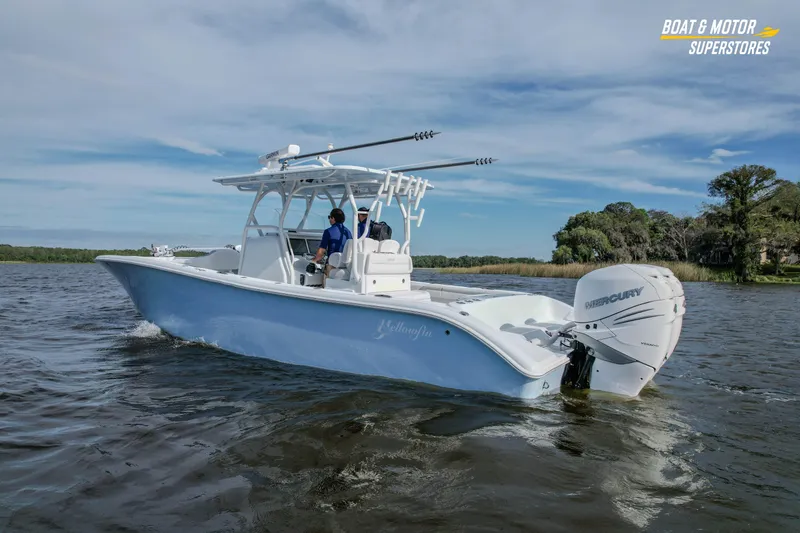 Slide: The Image of 2020 Yellowfin 32 Offshore boat cruising on a calm lake with two passengers. - 4