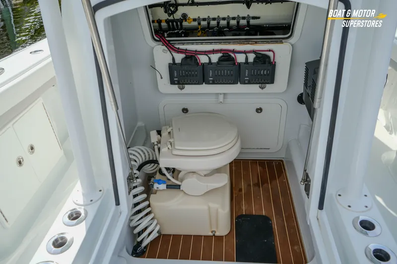 Slide: The Image of 2020 Yellowfin 32 Offshore boat interior with toilet and control panel. - 40