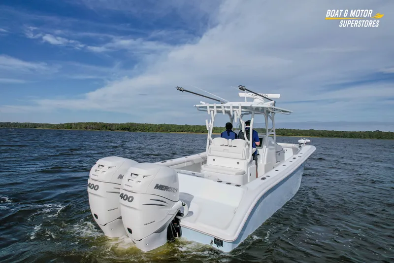 Slide: The Image of 2020 Yellowfin 32 Offshore boat cruising on a lake with twin Mercury engines. - 5