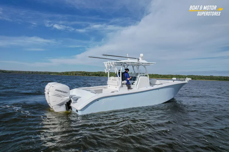 Slide: The Image of 2020 Yellowfin 32 Offshore boat cruising on a lake under a clear blue sky. - 56