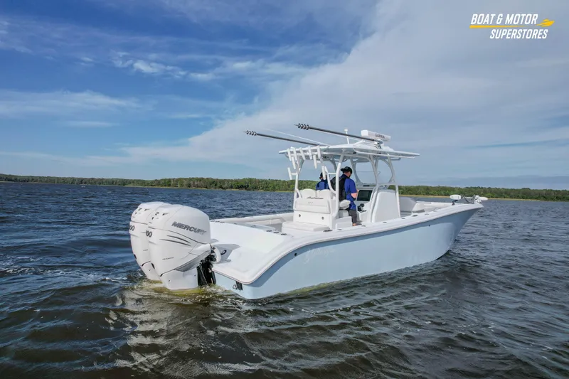 Slide: The Image of 2020 Yellowfin 32 Offshore boat cruising on a lake under a clear blue sky. - 57