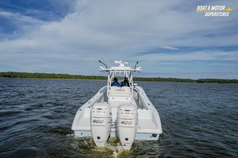 Slide: The Image of 2020 Yellowfin 32 Offshore boat cruising on open water with twin 400 engines. - 6