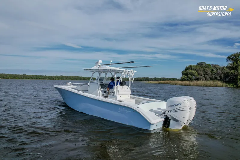 Slide: The Image of 2020 Yellowfin 32 Offshore boat cruising on a scenic lake with clear skies. - 7