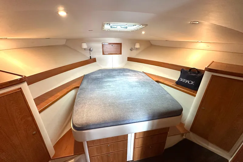 Slide: The Image of Interior cabin of 2002 Skipjack 36 Flybridge with bed and wooden storage. - 12