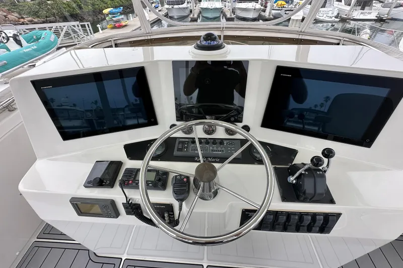 Slide: The Image of Helm of 2002 Skipjack 36 Flybridge with dual screens and navigation controls. - 15
