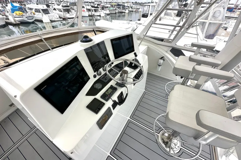 Slide: The Image of Flybridge of 2002 Skipjack 36, featuring modern navigation equipment and comfortable seating. - 16