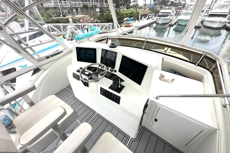 Slide: The Image of Flybridge of 2002 Skipjack 36, featuring modern controls and marina view. - 17