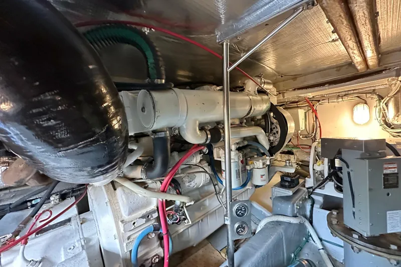 Slide: The Image of Engine room of 2002 Skipjack 36 Flybridge with visible machinery and wiring. - 20
