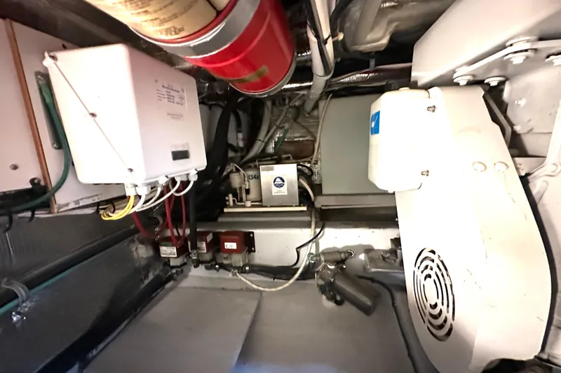 Slide: The Image of Engine room of a 2002 Skipjack 36 Flybridge with electrical components and fire extinguisher. - 21