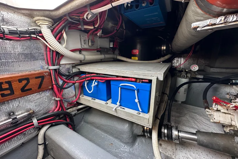 Slide: The Image of Engine compartment of 2002 Skipjack 36 Flybridge with wiring and battery storage. - 22