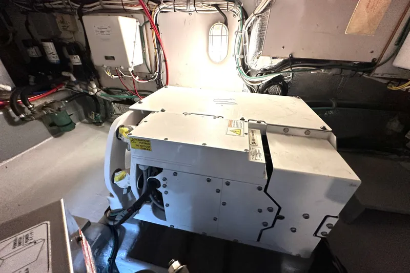 Slide: The Image of Engine room of 2002 Skipjack 36 Flybridge with visible wiring and equipment. - 26