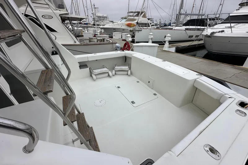 Slide: The Image of Spacious deck of 2002 Skipjack 36 Flybridge yacht docked at marina. - 29