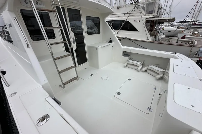 Slide: The Image of Spacious deck of 2002 Skipjack 36 Flybridge boat with ladder and storage compartments. - 30