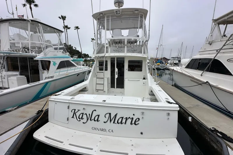 Slide: The Image of Skipjack 36 Flybridge 2002 boat docked at marina, labeled "Kayla Marie," Oxnard, CA. - 33