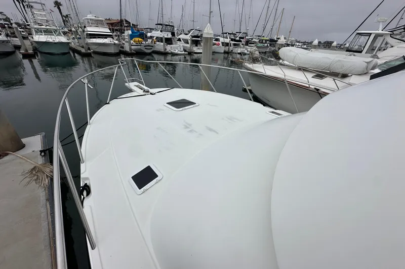 Slide: The Image of 2002 Skipjack 36 Flybridge yacht docked in a marina with other boats. - 5