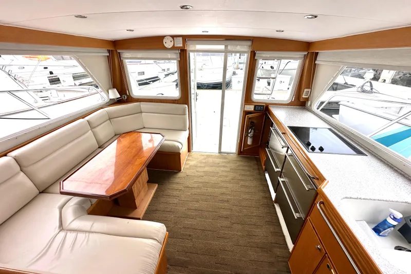 Slide: The Image of Luxurious interior of 2002 Skipjack 36 Flybridge yacht with modern kitchen and seating area. - 6