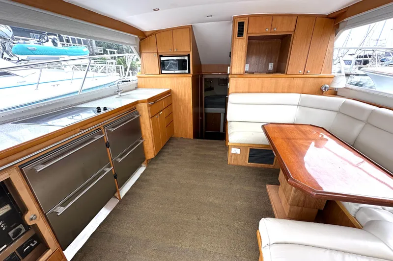 Slide: The Image of Interior of 2002 Skipjack 36 Flybridge yacht with kitchen and dining area. - 7