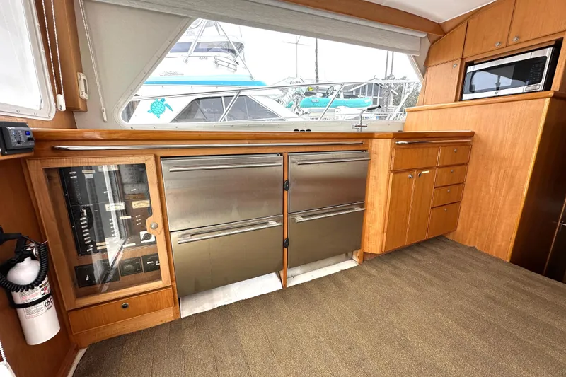 Slide: The Image of Interior of 2002 Skipjack 36 Flybridge with wood cabinetry and stainless steel appliances. - 8