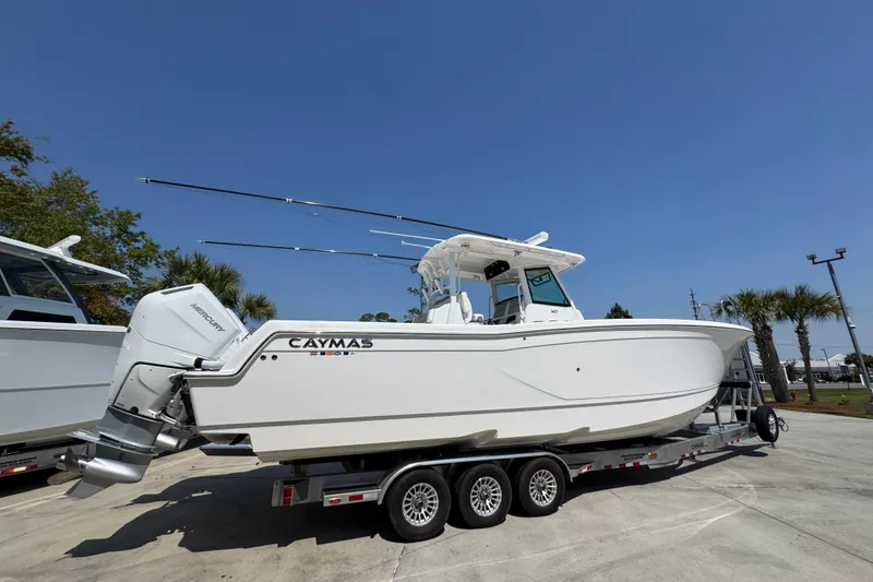 Slide: The Image of 2025 Caymas 34 CT boat on trailer under clear blue sky. - 11