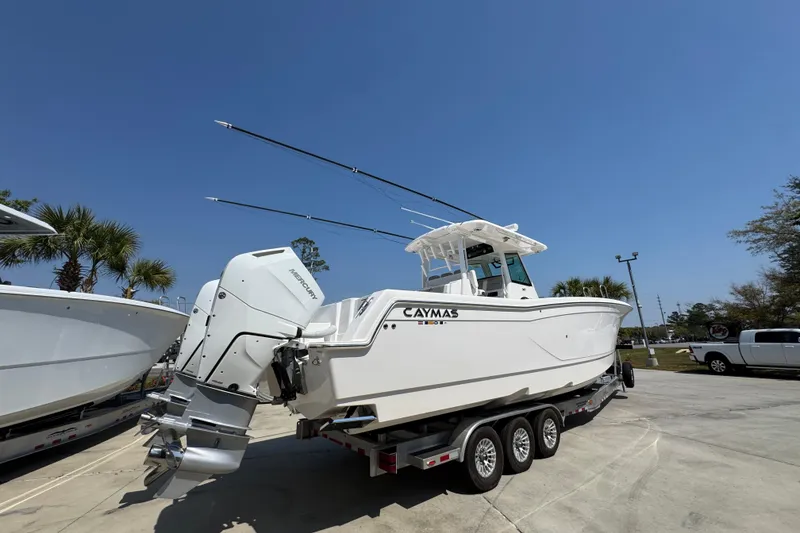 Slide: The Image of 2025 Caymas 34 CT boat on trailer under clear blue sky. - 12