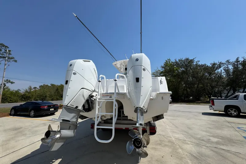 Slide: The Image of 2025 Caymas 34 CT boat with dual outboard motors in a parking lot. - 14