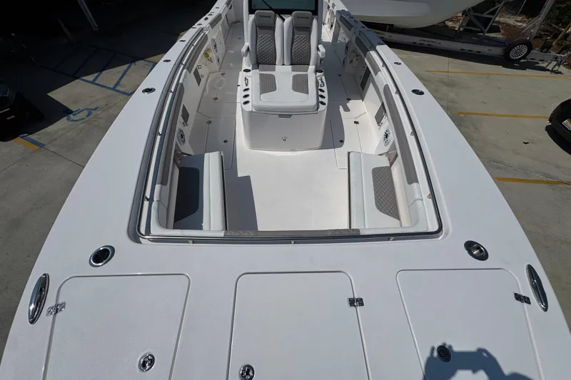 Slide: The Image of 2025 Caymas 34 CT boat interior with seating and storage compartments. - 22