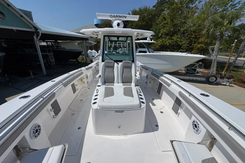 Slide: The Image of 2025 Caymas 34 CT boat with Garmin equipment, docked outdoors on a sunny day. - 24