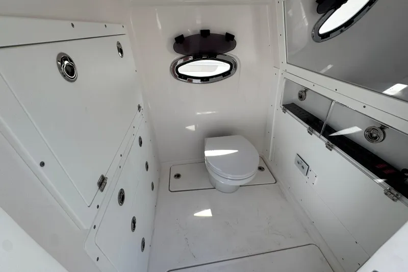 Slide: The Image of 2025 Caymas 34 CT boat interior bathroom with modern fixtures and porthole window. - 27