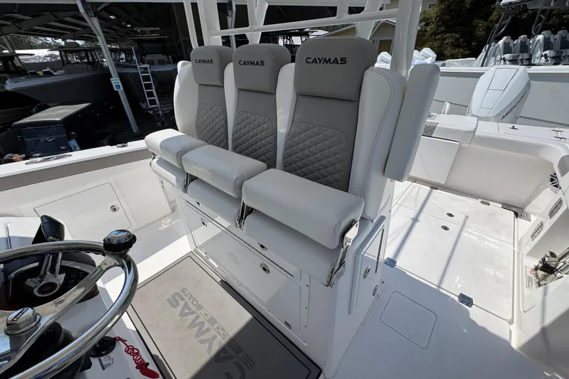 Slide: The Image of 2025 Caymas 34 CT boat interior with cushioned seating and steering wheel. - 29
