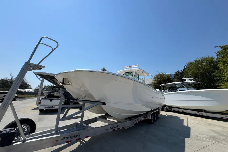 Slide: The Image of 2025 Caymas 34 CT boat on trailer under clear blue sky. - 3