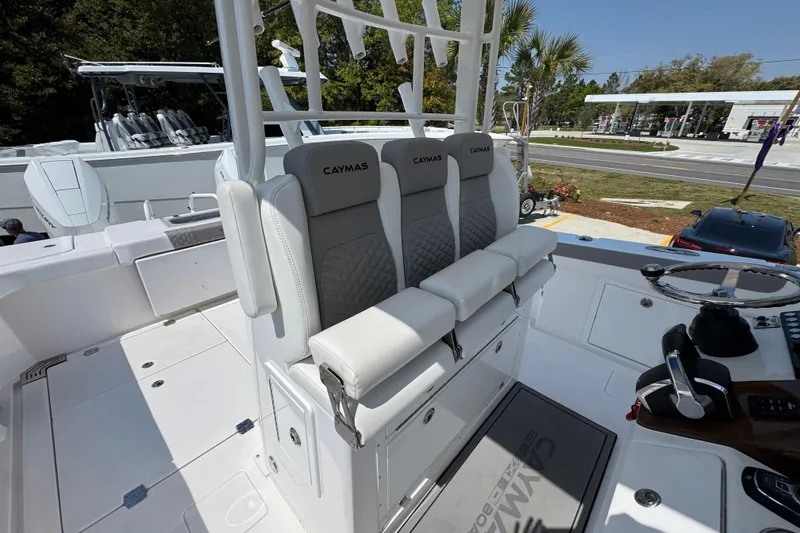Slide: The Image of 2025 Caymas 34 CT boat interior with cushioned seating and steering wheel. - 32
