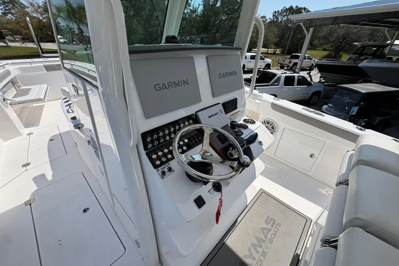 Slide: The Image of 2025 Caymas 34 CT boat cockpit with Garmin navigation system and steering wheel. - 33